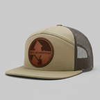 Beige cap with brown leather patch featuring 'Real Momentum' logo on a white background