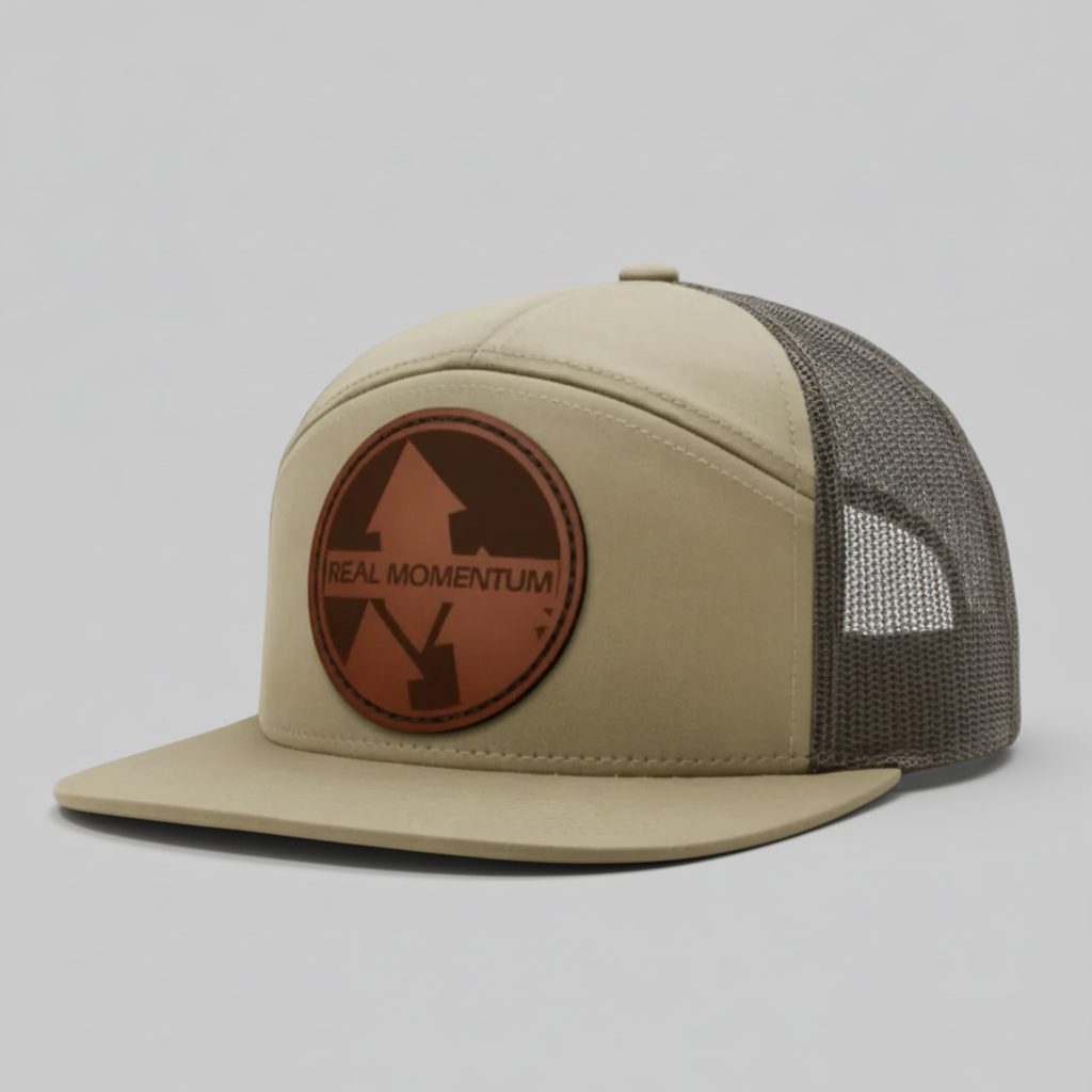 Beige cap with brown leather patch featuring 'Real Momentum' logo on a white background