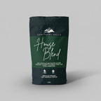 Coffee bag labeled 'House Blend' from Sanctuary Hills on a light gray background