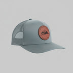 Gray cap with a red leather patch on a light gray background