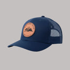 Navy blue cap with a leather patch on a light gray background