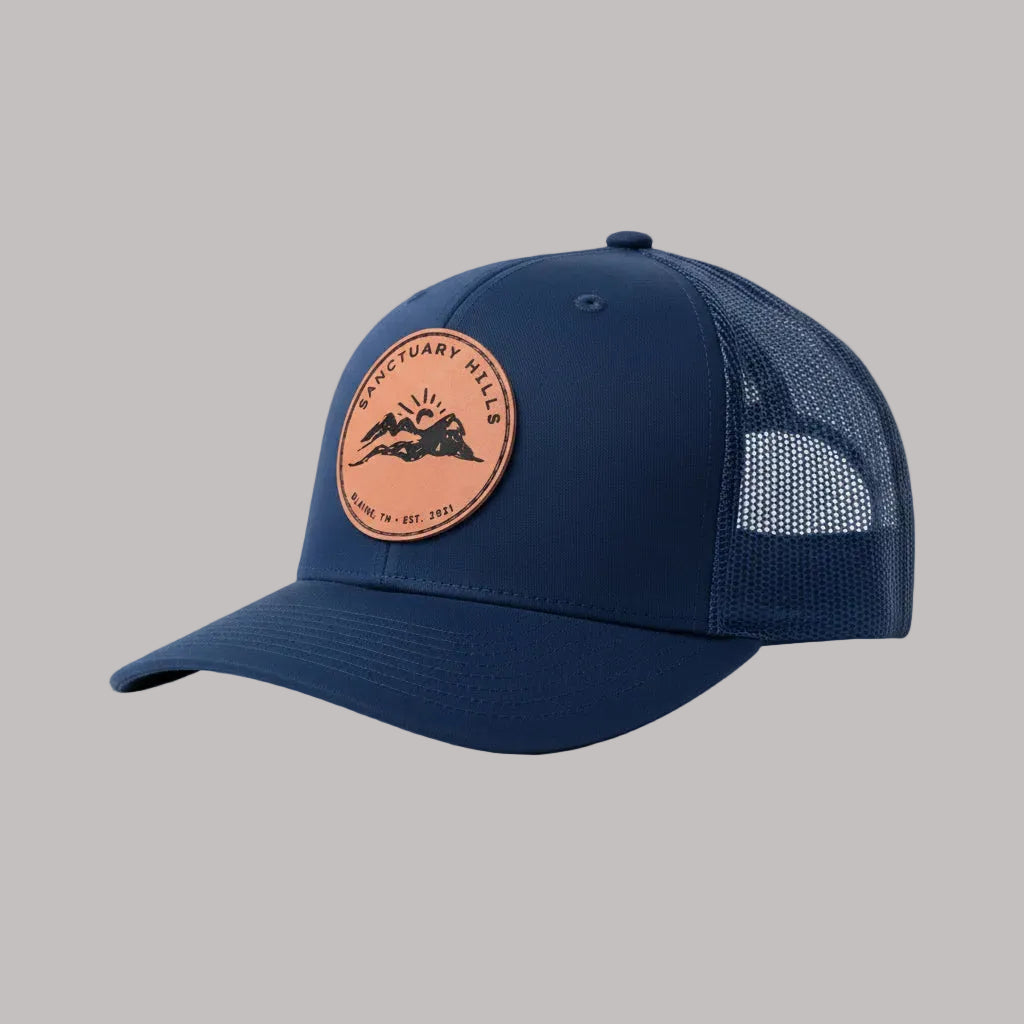 Navy blue cap with a leather patch on a light gray background