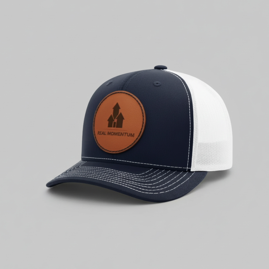 Navy and white cap with a brown leather patch on a gray background