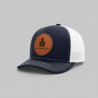 Navy and white cap with a brown leather patch on a gray background