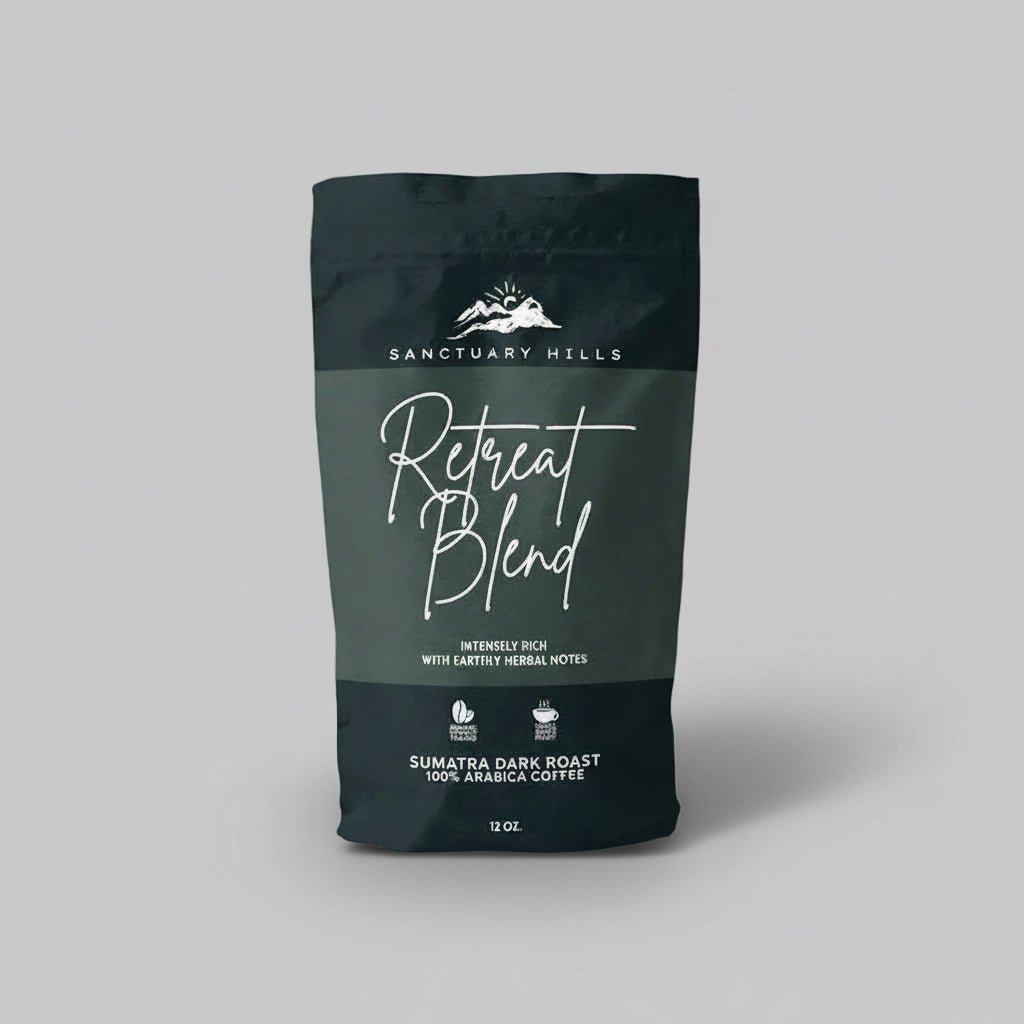 Dark green coffee bag labeled 'Retreat Blend' by Sanctuary Hills on a light gray background